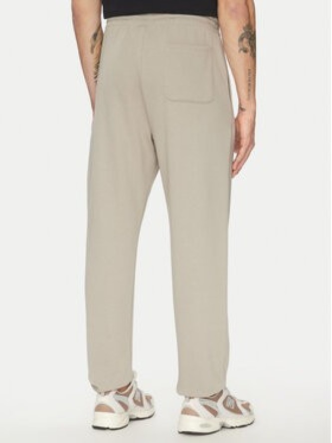 New Balance Spodnie dresowe Essentials MP41519 Beżowy Relaxed Fit