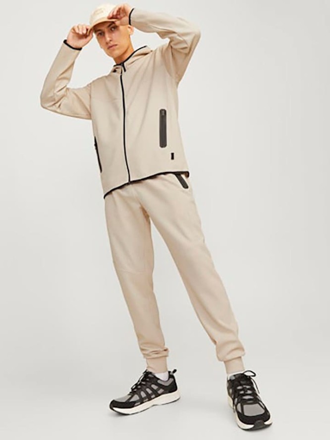 Jack & Jones Spodnie dresowe w kolorze kremowym rozmiar: M