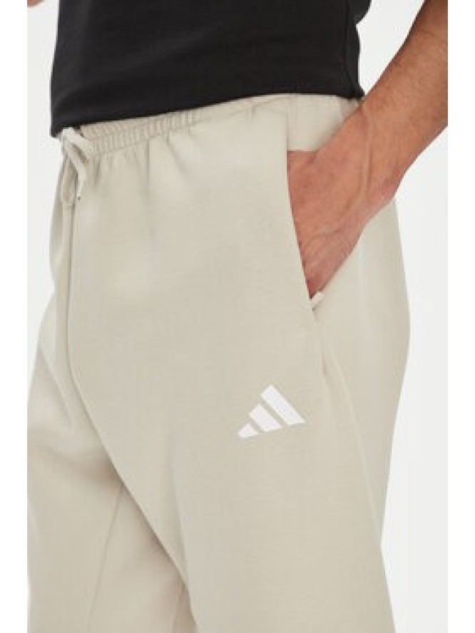 adidas Spodnie dresowe Future Icons 3-Stripes JW7092 Beżowy Regular Fit