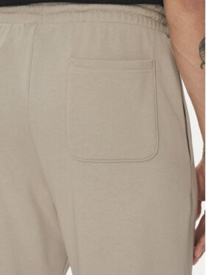 New Balance Spodnie dresowe Essentials MP41519 Beżowy Relaxed Fit